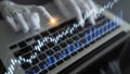 Futuristic robotic hand interacting with digital financial chart data on a laptop, representing technology, analytics Royalty Free Stock Photo
