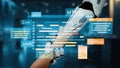 Futuristic robotic hand interacting with digital programming languages and code blocks in a modern tech environment Royalty Free Stock Photo