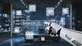 Futuristic robotic hand interacting with a digital search bar in a modern office environment using advanced technology Royalty Free Stock Photo