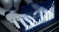 Futuristic robotic hand interacting with financial data on a laptop displaying dynamic charts and graphs for advanced Royalty Free Stock Photo