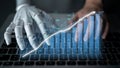 Futuristic robotic hand interacting with laptop keyboard while analyzing financial data with graphical charts and Royalty Free Stock Photo