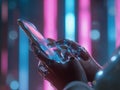 Futuristic robotic hand interacting with a smartphone in a neon-lit environment Royalty Free Stock Photo