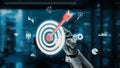 Futuristic robotic hand targeting digital interface with various icons representing data analysis, business strategy Royalty Free Stock Photo
