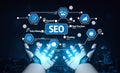 Futuristic Robotic Hands Presenting SEO Concepts with Data Mining, Keywords, Best Practices, and Planning Over a Digital Royalty Free Stock Photo