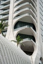 Futuristic shape building showing balconies with curve glass railing