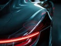 Futuristic sleek car with illuminated tail light and wireless charging indicator Royalty Free Stock Photo