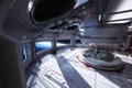 Futuristic space station interior overlooking a planet with a center atrium.