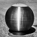 Futuristic spherical waste bin made of shiny metal