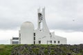 Futuristic Stykkisholmskirkja church in Stykkisholmur, Iceland in cloudy weather from back