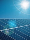 Futuristic sunny background of solar power plant with sun and blue sky Royalty Free Stock Photo