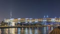 Futuristic Pedestrian Bridge over the Dubai Water Canal Illuminated at Night timelapse, UAE. Royalty Free Stock Photo