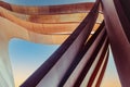 Futuristic urban architecture. Art arch vertical triangles made of brown tin metal with a blue sky background. Abstract Royalty Free Stock Photo