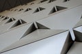 Futuristic Wall of relief metallic triangles. 3d geometric background. low angle view Royalty Free Stock Photo