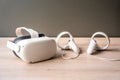 Futuristic white virtual reality goggles and earphones