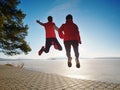 Fuuny happy lovers jump together. Woman and man hand in hand Royalty Free Stock Photo