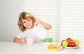 Fuuny little boy pouring whole cows milk for breakfast. Kid preteen boy 7, 8, 9 years old eating healthy food vegetables Royalty Free Stock Photo