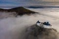 Fuzer, Hungary - Aerial panoramic view of the beautiful Castle of Fuzer standing out of the fog on an foggy autumn morning