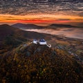 Fuzer, Hungary - Aerial view of the beautiful Castle of Fuzer with amazing colorful golden sunrise and clouds on an autumn morning