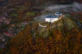 Fuzer, Hungary - Aerial view of the beautiful Castle of Fuzer on a hilltop with colorful autumn foliage on a foggy morning Royalty Free Stock Photo