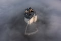 Fuzer, Hungary - Aerial view of the beautiful Castle of Fuzer standing out of the fog on an autumn morning