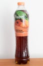 Fuzetea black iced tea peach hibiscus tea in plastic bottle. Fuze tea is brand owned by Coca-Cola Company.