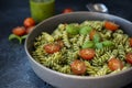 Fuzzily Italian pasta with pesto on black concrete background. Royalty Free Stock Photo