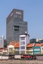 FWD tower with garden behind restaurant row in Singapore