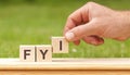 FYI concept of governance and social environment. hand holding wooden cube with letter I