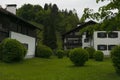 FÃÂ¼ssen, Germany 27 May 2019 - Cozy alpine houses with wooden roofs lost in green rainy valley among mountains. Little german