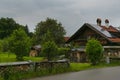 FÃÂ¼ssen, Germany 27 May 2019 - Cozy alpine houses with wooden roofs lost in green rainy valley among mountains. Little german