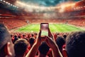 A 5G enabled smartphone in a football game in the hands of a fan