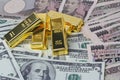 5 of  999.9 % of 1000 g Gold bars  placed on dallar banknotes  and Yen bank notes Royalty Free Stock Photo