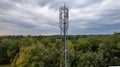 3G, 4G, 5G. Mobile phone base station Tower. Development of communication system in npn-urban forest area with dark