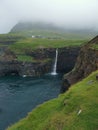 GÃ¡sadalur village with the famous MÃºlafossur waterfall in a cloudy day, VÃ¡gar, Faroe Islands