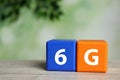 6G technology, Internet concept. Color cubes on wooden table Royalty Free Stock Photo