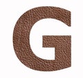 G uppercase alphabet letter - Brown leather texture background