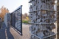 Gabion. Automatic entrance gate used in combination with a wall made of gabion