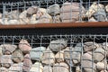 Gabion fence wall from steel mesh with stones . Gabion wire mesh fencing