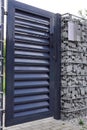 Gabion wall. Entrance door with access control system and intercom