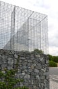 Gabion wire basket, cages. fence in the front garden with a natural industrial look. made of galvanized wire. retaining wall fille