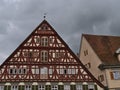 Gable of old half-timbered house at the town square of Esslingen am Neckar, Germany on cloudy summer day.
