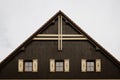 Gable roof of cottage with grey clouds in background Royalty Free Stock Photo