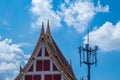 Gable roof of temple and telephone pole. Royalty Free Stock Photo