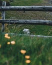 Gable-roofed house seen through the roadside wooden fence Royalty Free Stock Photo