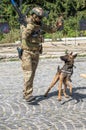 Training of a military dog and a special forces soldier. Demonstration of attack with fighting dogs and machine gun fire, close Royalty Free Stock Photo