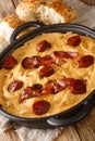 Gachas manchegas with bacon and chorizo Delicious simple Spanish food close-up in a pan. Vertical