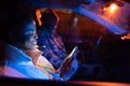 Gadget addicted man and woman couple sit in car in silence using smartphones browsing social media Royalty Free Stock Photo