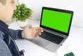 The sick man looks at the computer. The gadget has a green screen instead of a monitor. The concept of remote health care and Royalty Free Stock Photo