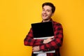 Gadget Lover. Excited man hugging laptop at studio Royalty Free Stock Photo