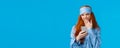 Gadgets addication, lifestyle and beauty concept. Lovely redhead girl going sleep and scrolling feed smartphone, yawning